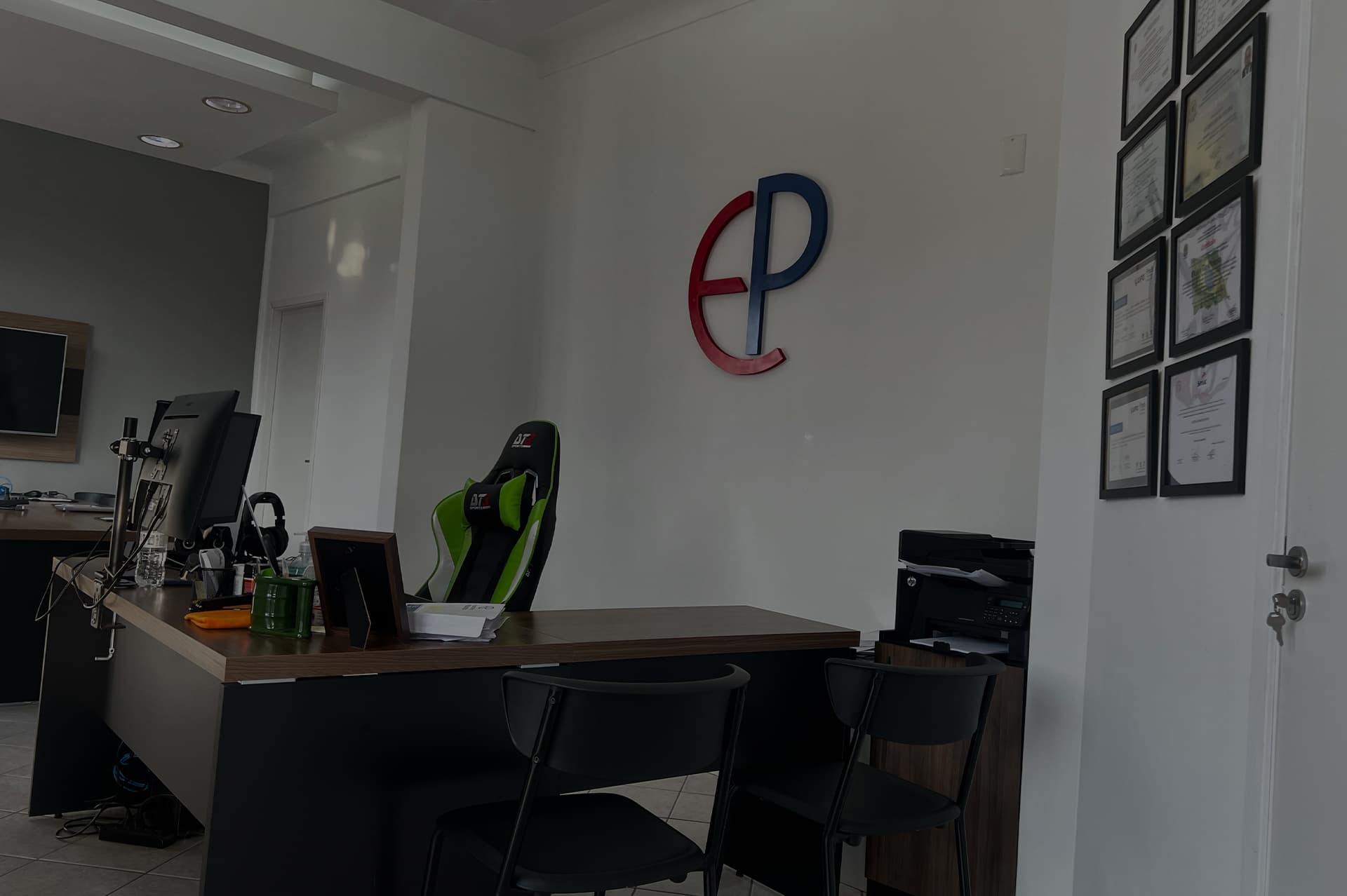 Recepção do Escritório Palombo, com o monograma EP na parede